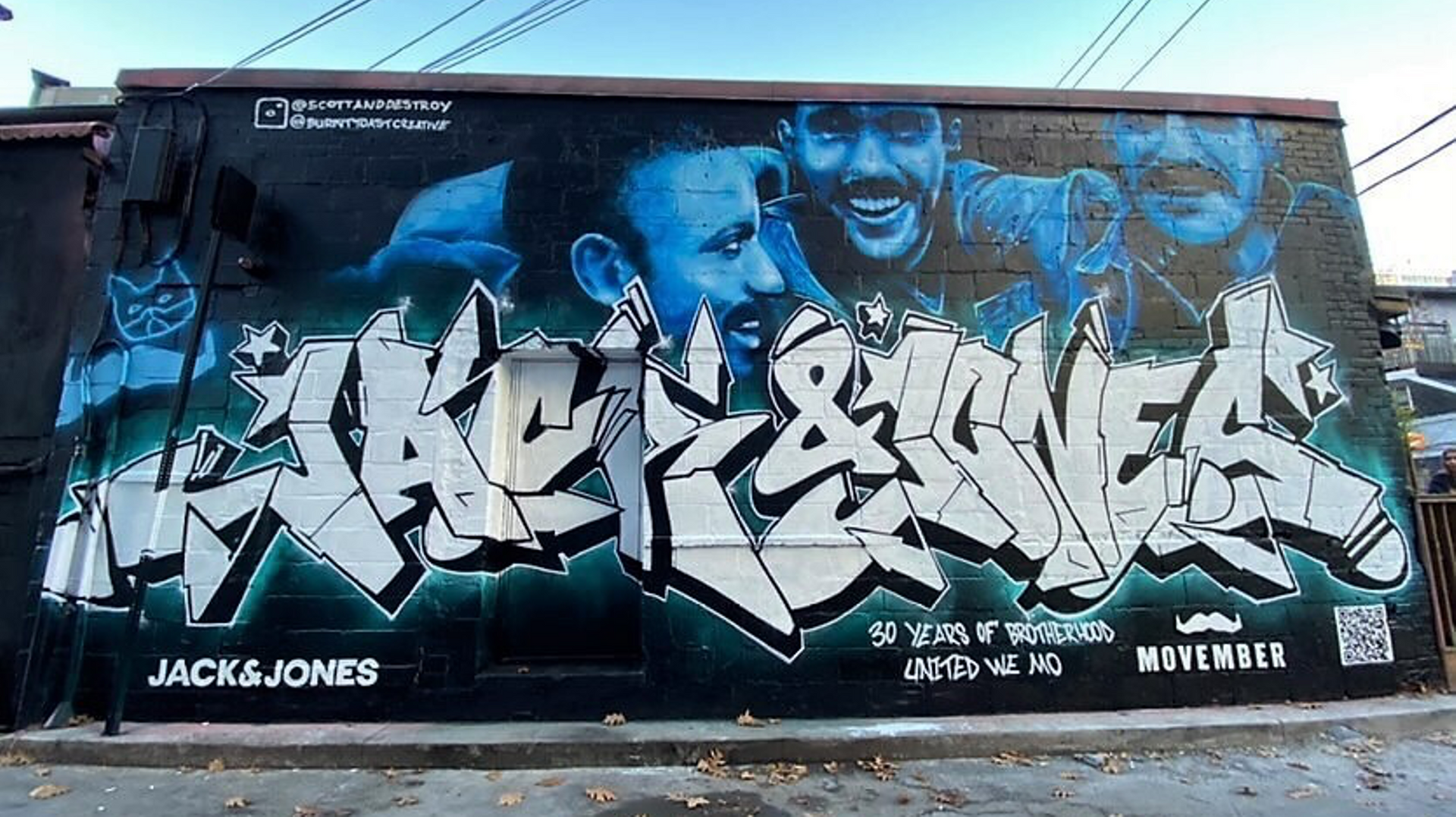 Graffiti art on side of building reading JACK & JONES