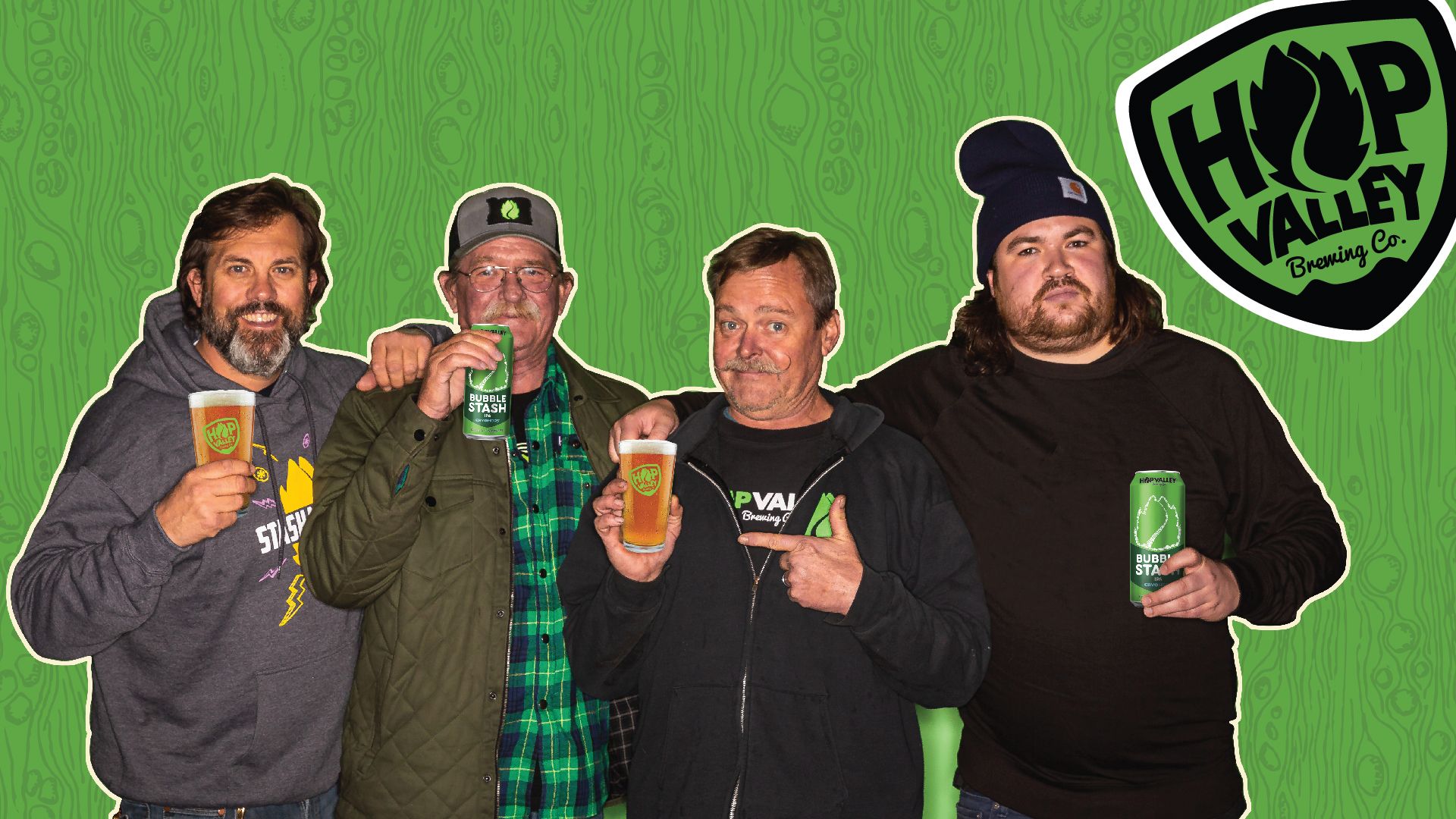 4 men from Hop Valley Brewing smile for the camera holding their Bubble Stash beer