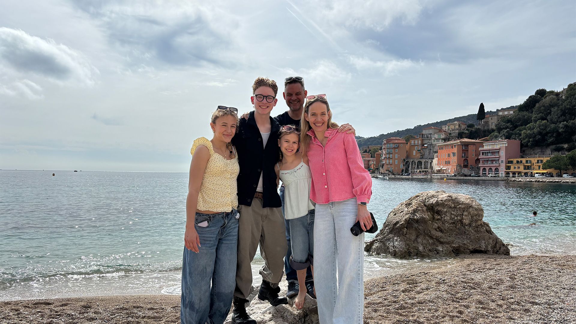 A family posing together at a beach in Vancouver