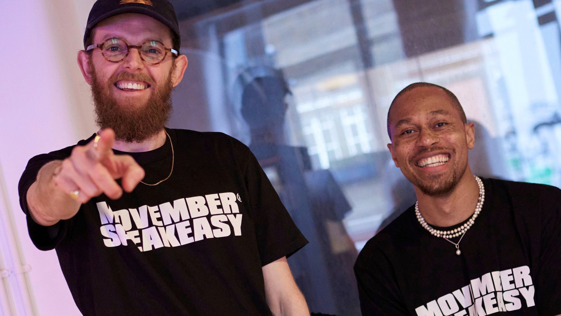 two young men wearing Movember Speakeasy t-shirts