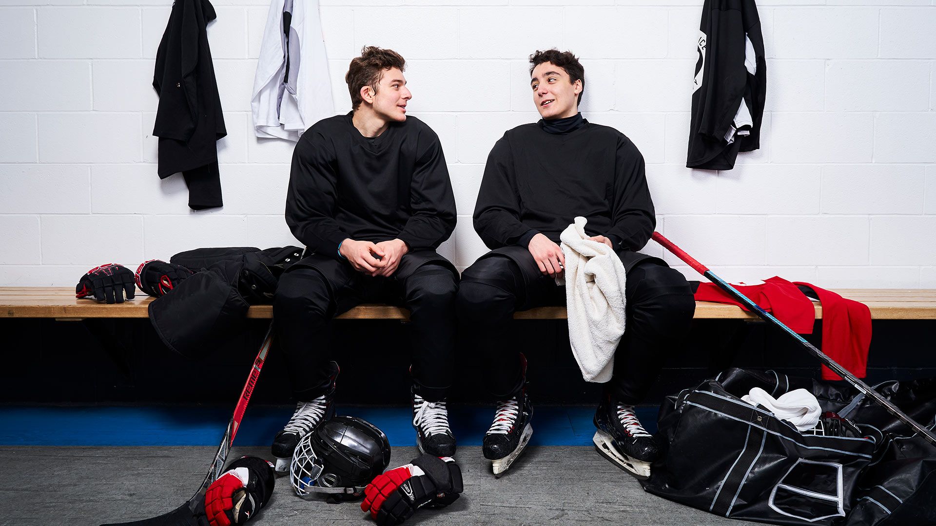 Two hockey players chatting in the changing rooms