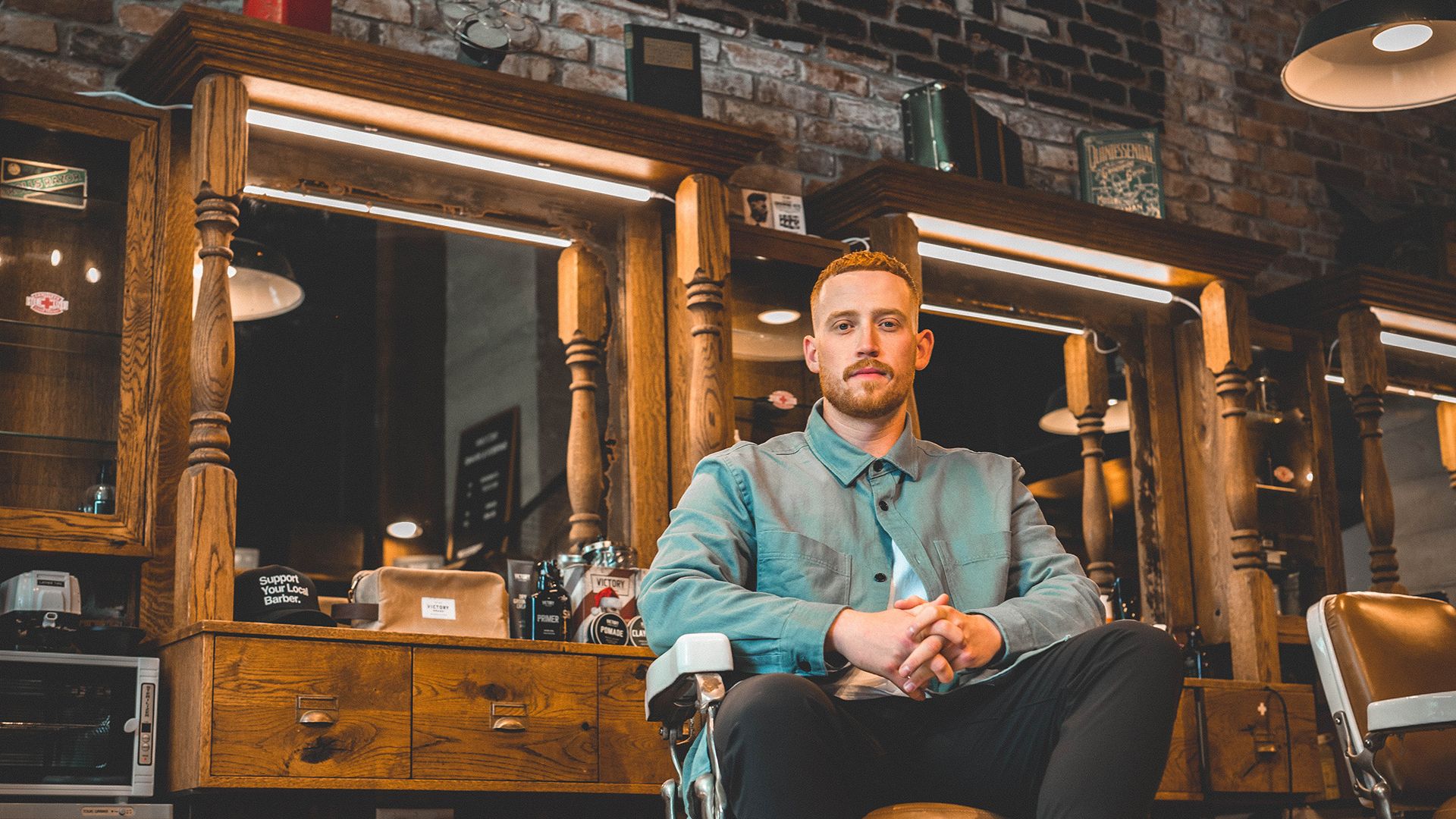 Mo Bro Ryan sits in a Vancouver barbershop