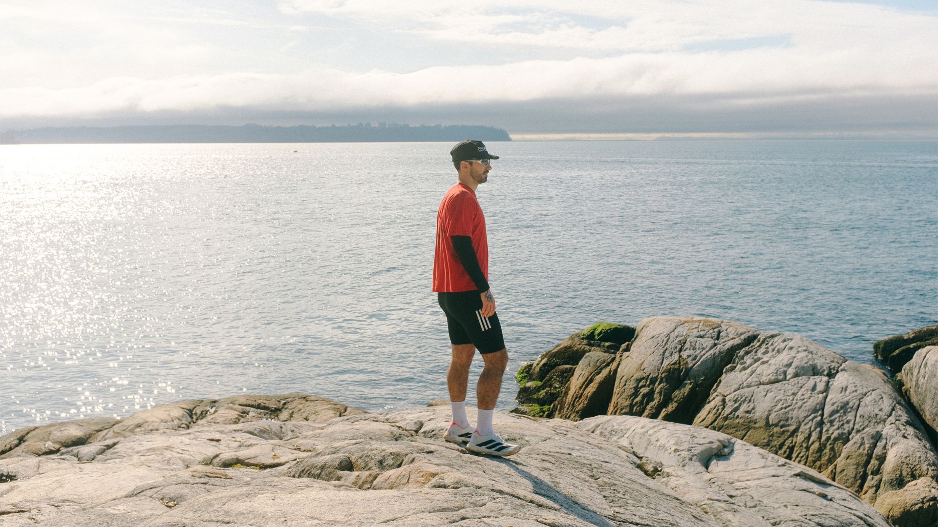 Male runner looks out over the ocean