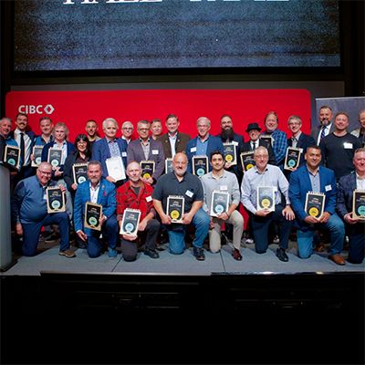 Photo of Movember Hall of Fame recipients receiving awards on a stage.