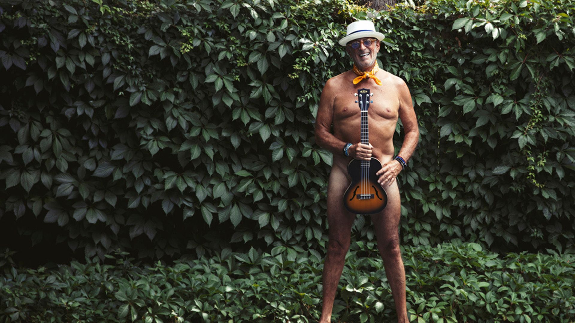 man standing with strategically placed ukulele