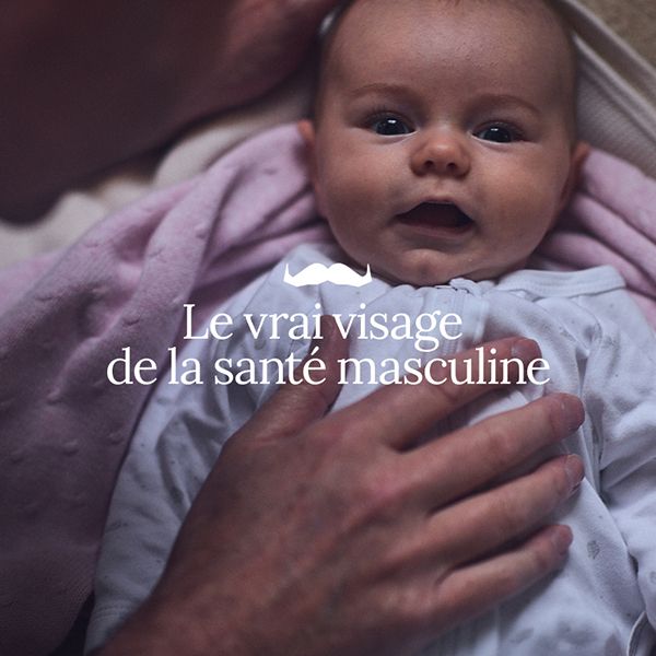 Photo of an infant looking to camera, cradled in adult hands. Superimposed text says in French: "The Real Face of Men's Health"