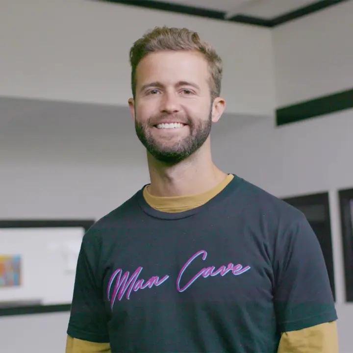 Young man with Man Cave shirt helping raise awareness for men's mental health.