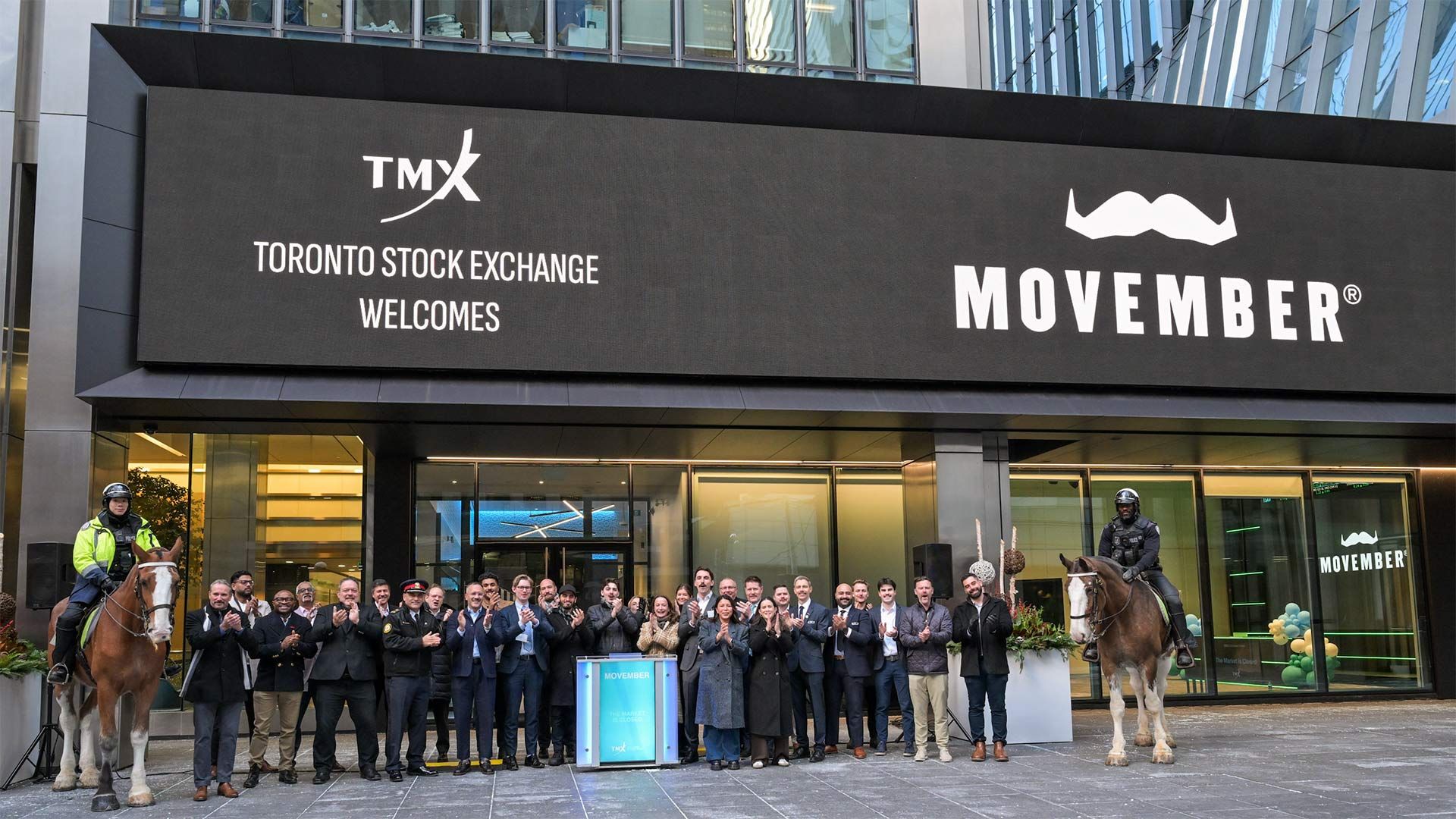 Photo of Movember personnel in front f the Toronto Stock Exchange building.
