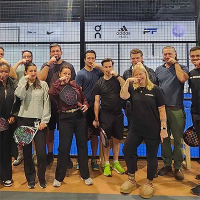 Photo of Canso employees posing in sportsgear before playing a round of pickleball