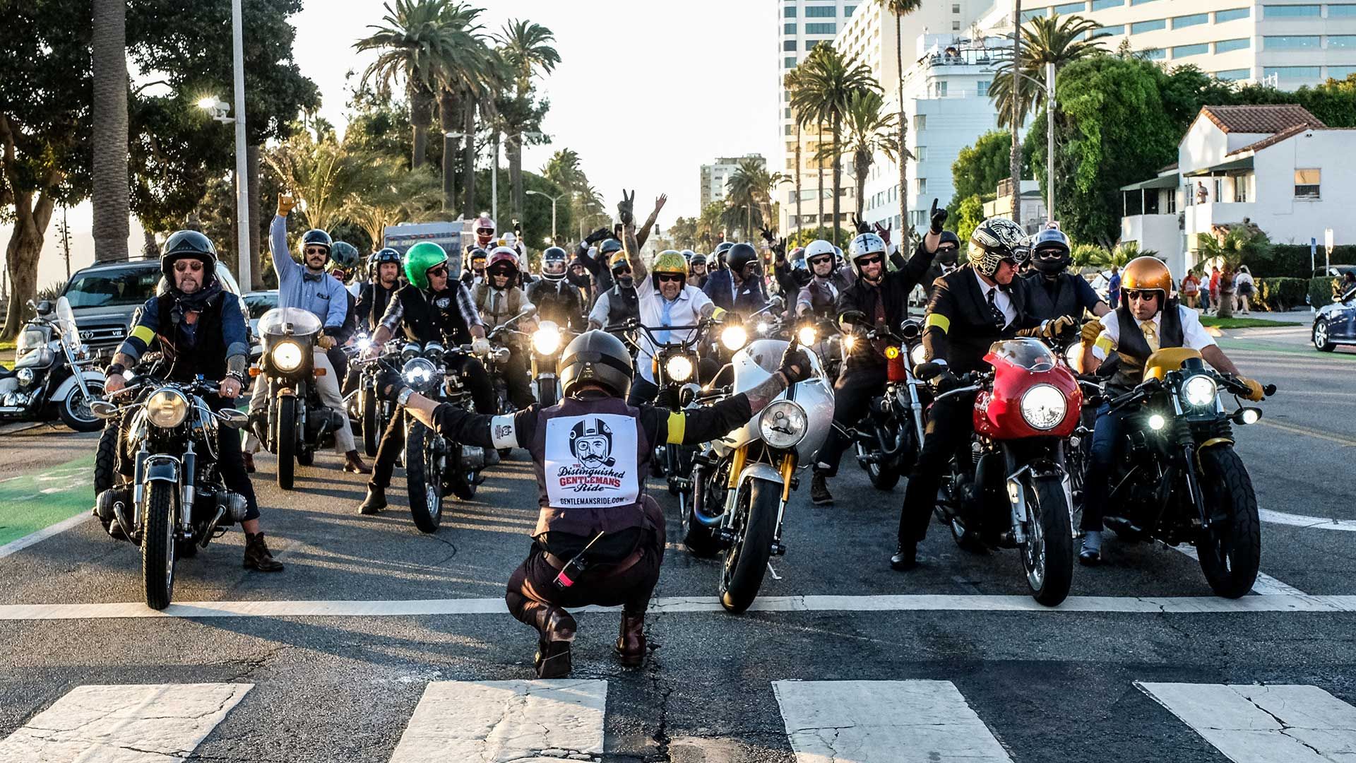A group of motorcycle riders line up on the starting line of The Distinguished Gentleman's Ride