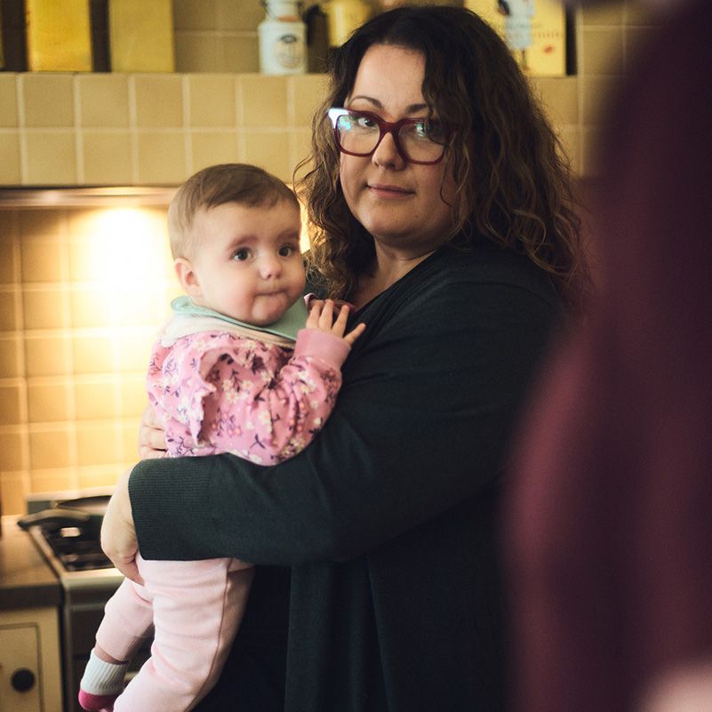 Photo of a mother holding a child.
