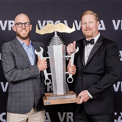 Photo of team in blue AMP-branded activewear, high-fiving enthusiastically after completing a 45-storey stair climb.