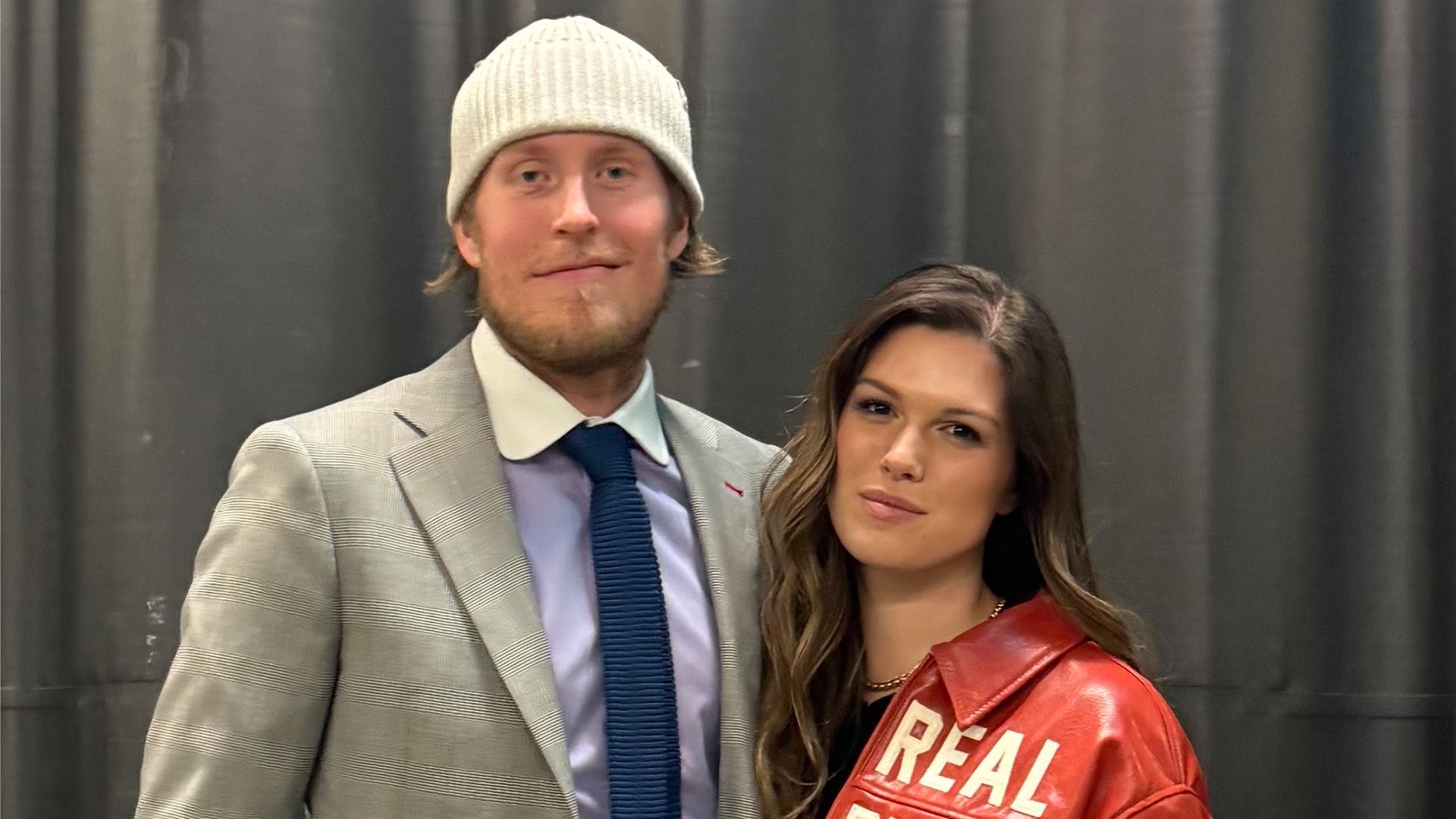 Patrik and Jordan Laine pose in front of a grey background.