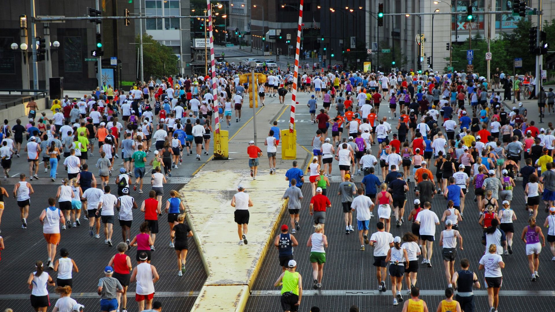 Marathon runners running over a bridge