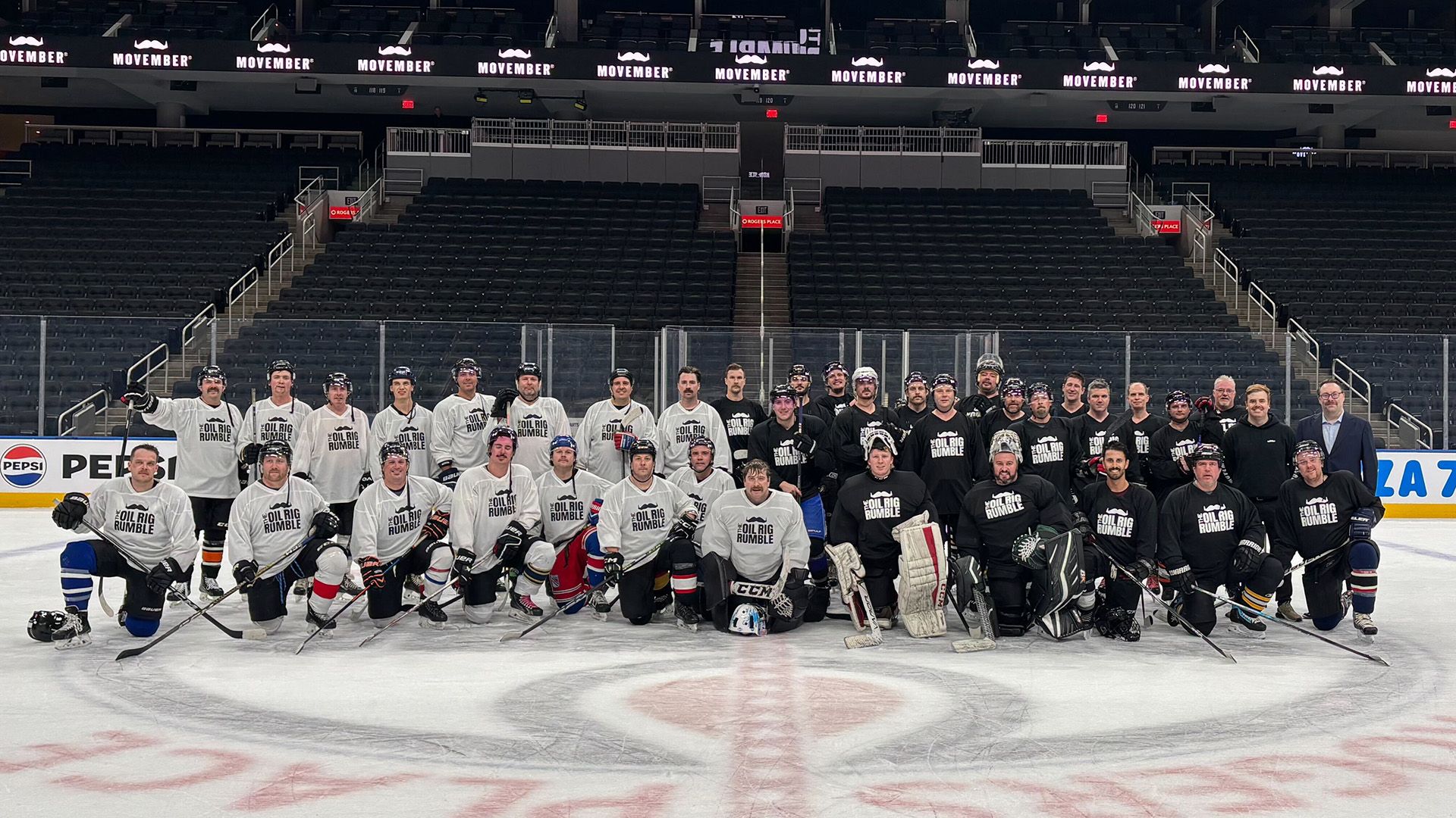 A group of men in hockey gear posing on an ice rink for Oil Rig Rumble